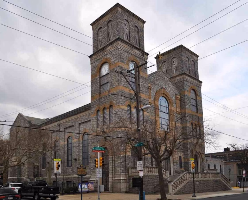 St. Monica’s Church in South Philadelphia with twin stone towers and clock on Ritner Street