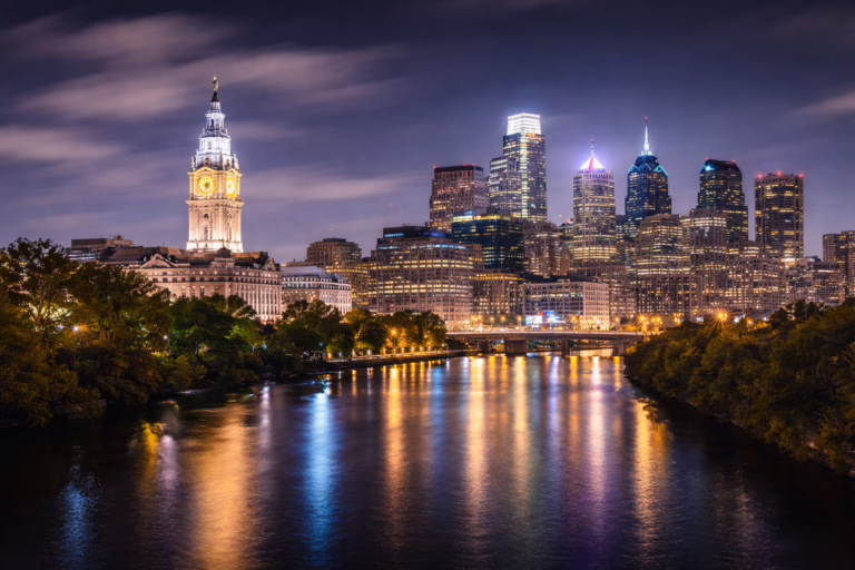 Philadelphia skyline with City Hall illuminated at night over the Schuylkill River in Center City Philadelphia