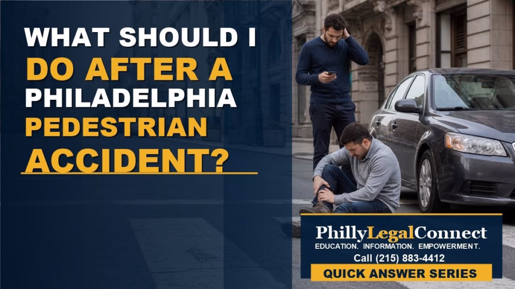 Pedestrian sitting in a Philadelphia street holding his leg after being hit by a car.