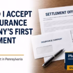 Insurance company’s first settlement offer after a Pennsylvania car accident, with a settlement letter and damaged vehicle.