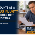 Man with a wrist brace reviewing accident medical records beside text about serious injury under Pennsylvania Limited Tort.