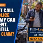 Concerned driver checks his phone beside two damaged cars after a Philadelphia accident when police were not called.